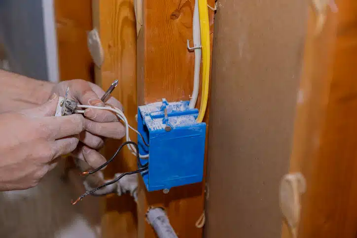 Preparing to remove an electrical outlet of the screws for electrical wires receptacle plug panel